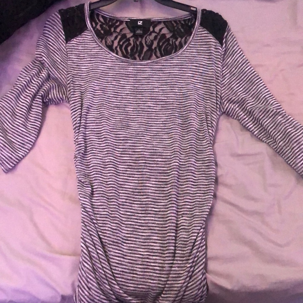 Tight fitting black and white striped shirt with rose lace pattern on back